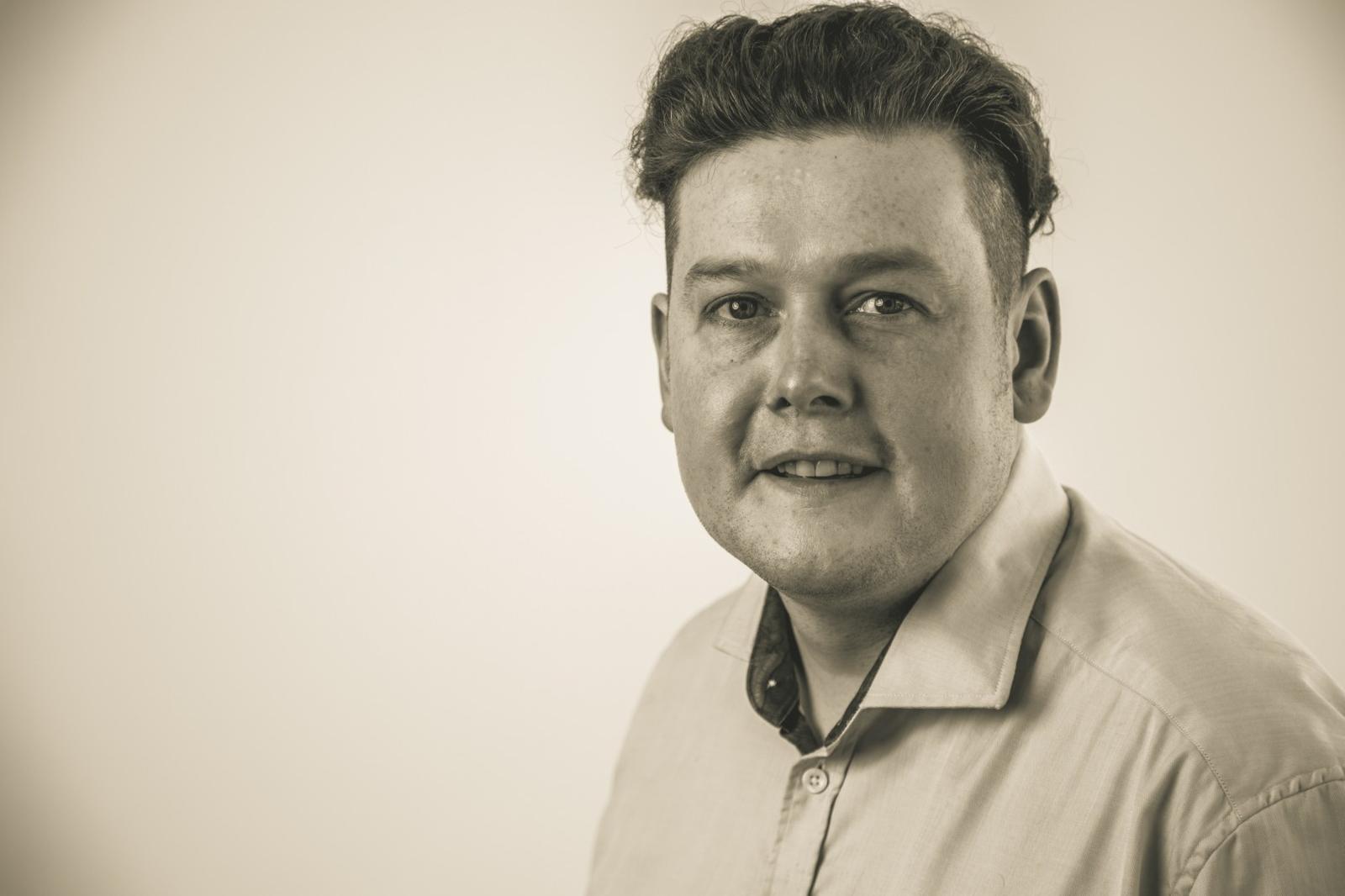 A black and white image of Damian Walsh. He is a director at Martin Walsh Architectural (MWA).