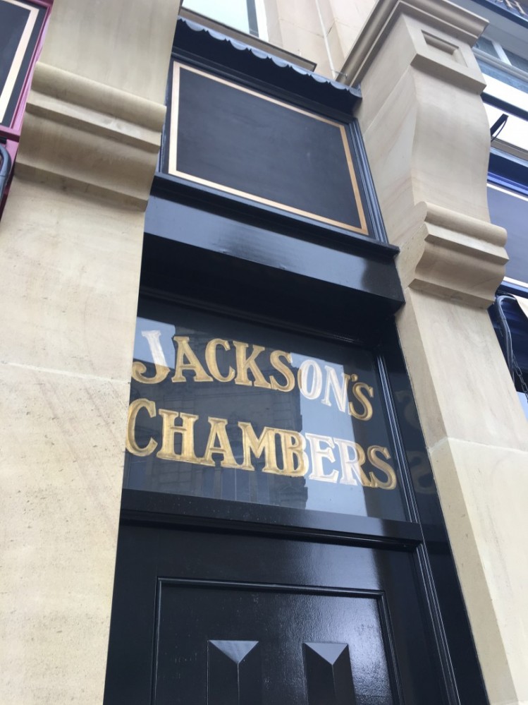 A close up image of Jackson's Chambers logo at the door of a door.