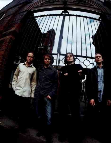 An image of the band, Gravel, infront of large gates.