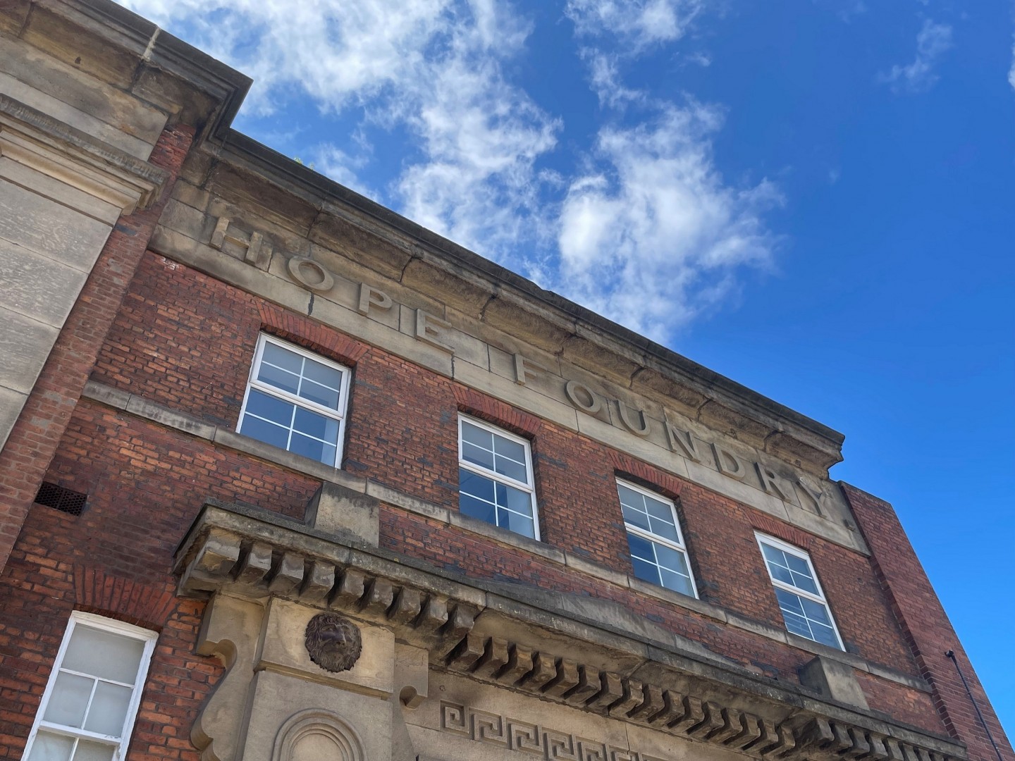 An image of an upward shot from the ground to the sky, of the Hope Foundry building.