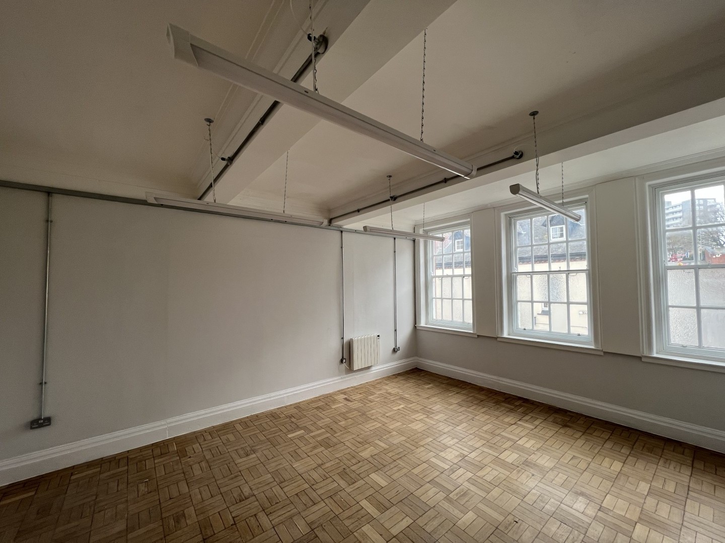 An image showing what the inside of the space looks like for MAP Charity. This is an image of a room showing the restored parquet flooring.