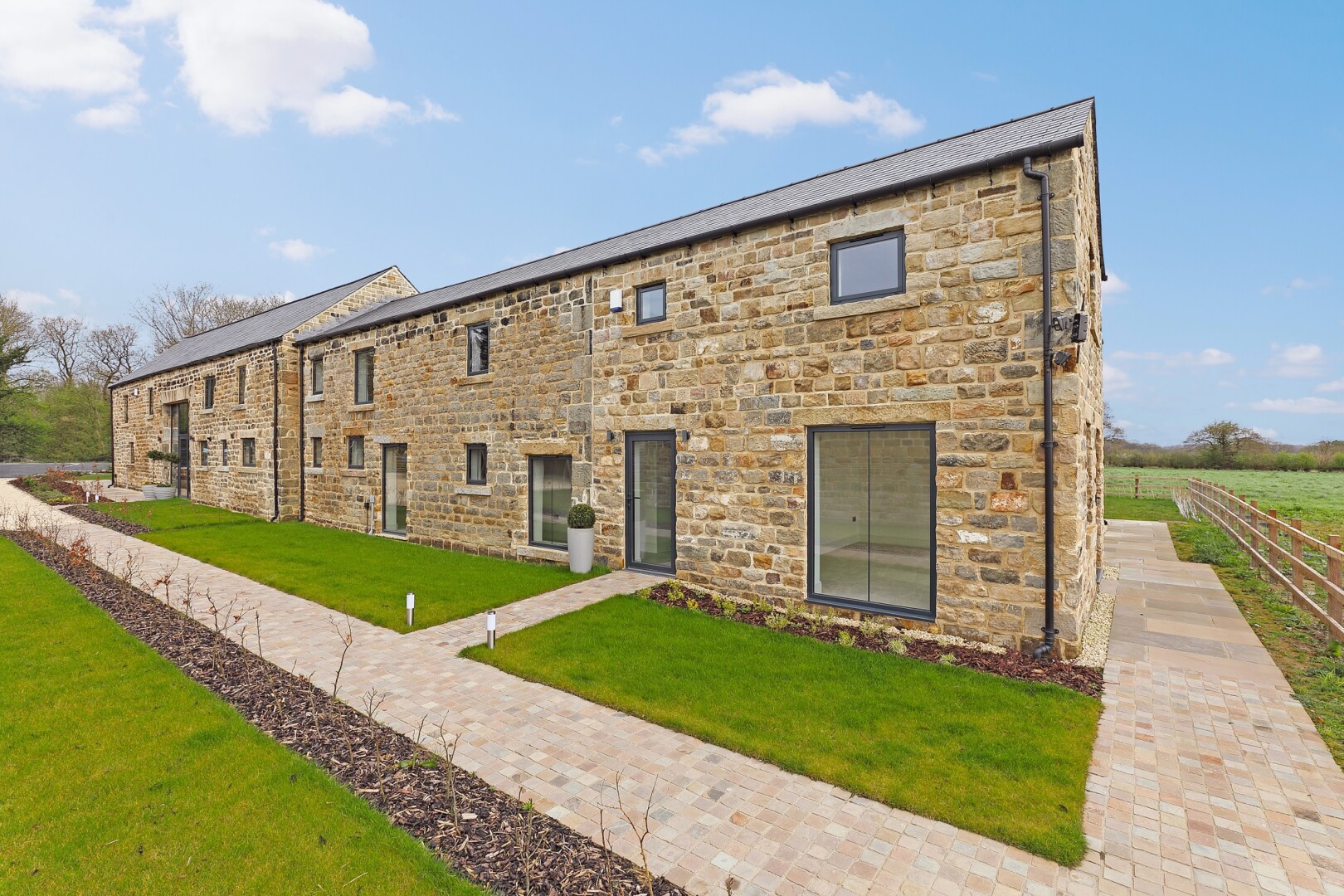 Photograph of Highfield Barn, the converted barn at Flying Horse Farm in Scholes. The image shows a view of the front of the building.