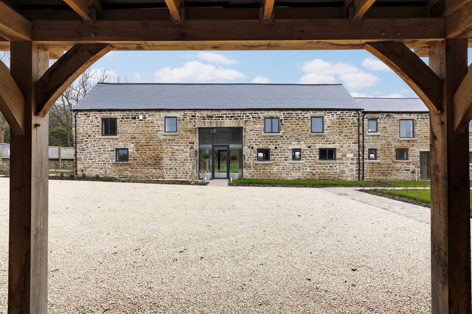 Photograph of Saw Wood Barn, the converted barn at Flying Horse Farm in Scholes. The image shows a view of the front of the building.